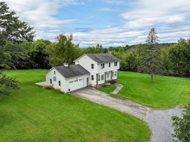 exterior space featuring entry steps, an attached garage, driveway, a front lawn, and a chimney