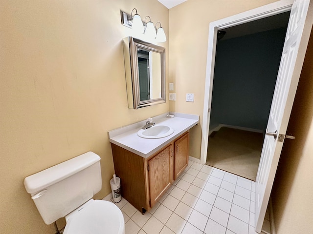 bathroom with tile patterned flooring, vanity, and toilet