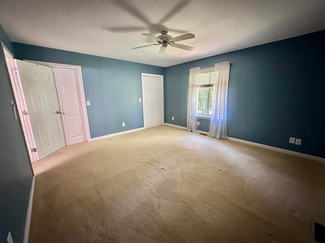 unfurnished bedroom with ceiling fan and carpet floors