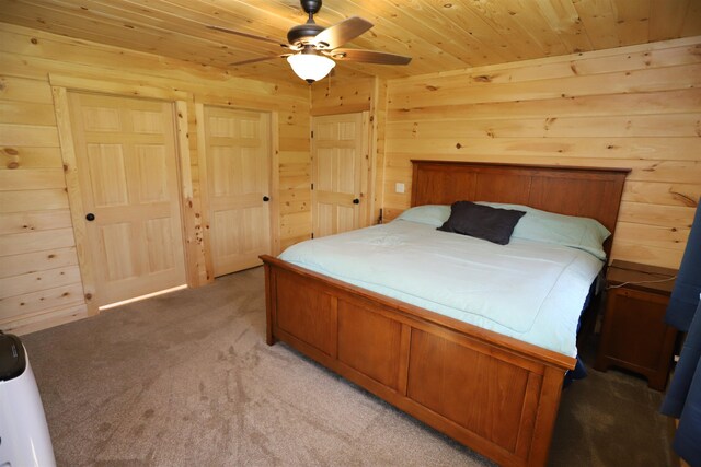 carpeted bedroom featuring ceiling fan and wood ceiling