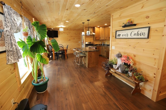 interior space with wood walls, dark wood-type flooring, and wooden ceiling