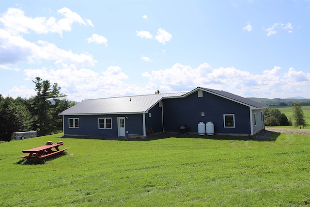 rear view of house with a yard