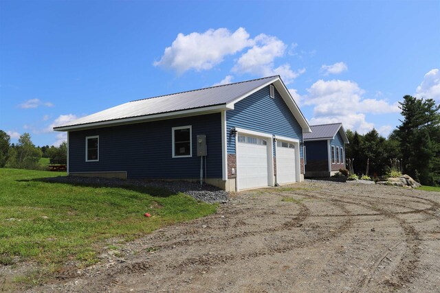 view of home's exterior with a yard and a garage