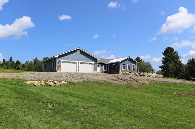 single story home featuring a garage and a front yard