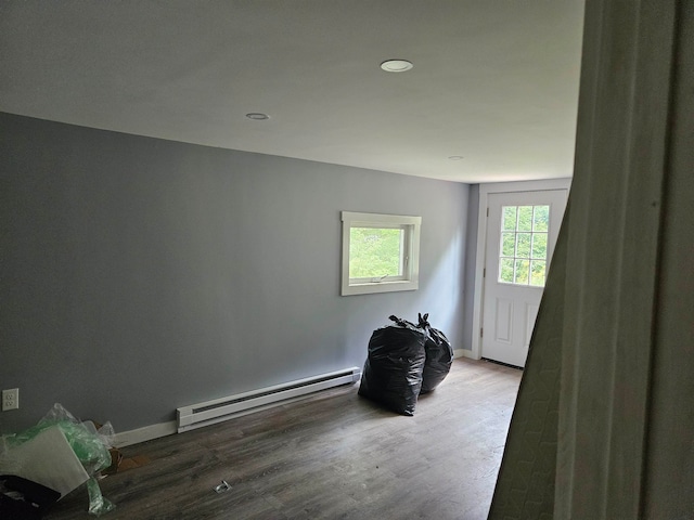 interior space featuring a baseboard radiator and hardwood / wood-style flooring