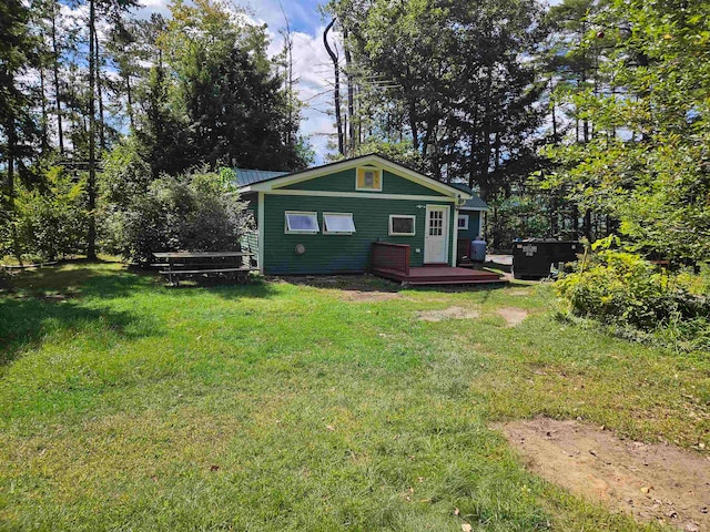 view of front of house featuring a front lawn and a deck