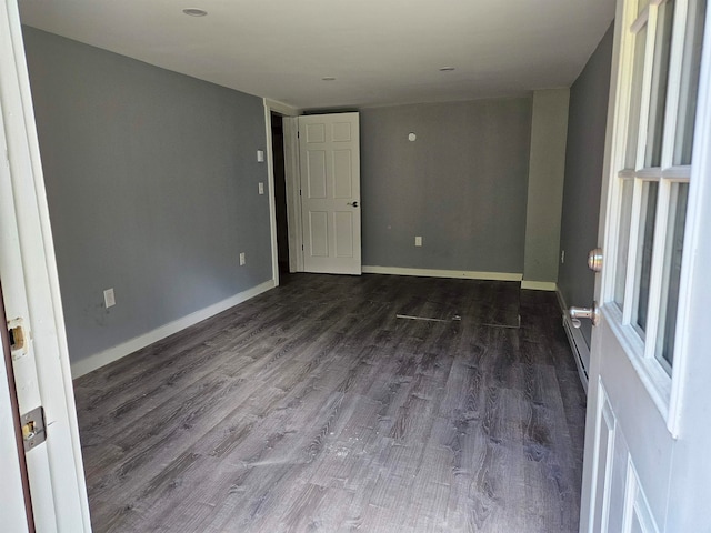 empty room featuring dark hardwood / wood-style flooring