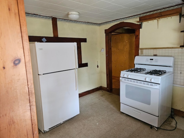 kitchen featuring white appliances and tile walls