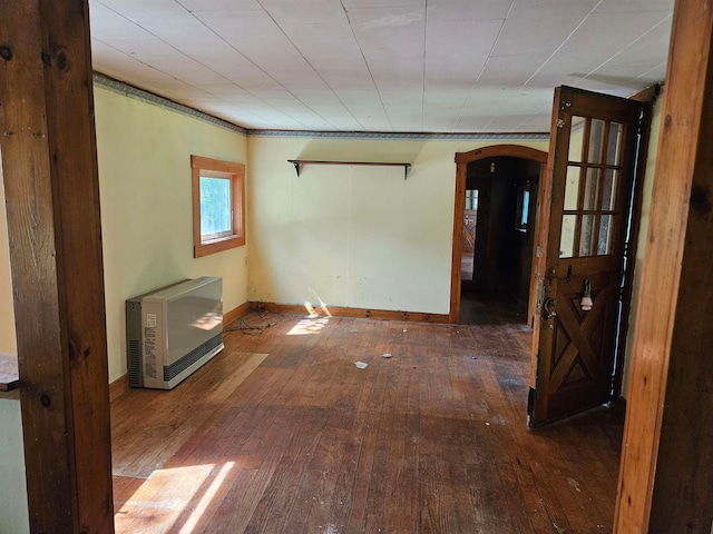 unfurnished room featuring hardwood / wood-style flooring and heating unit