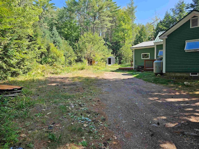 view of yard with a storage shed and a deck