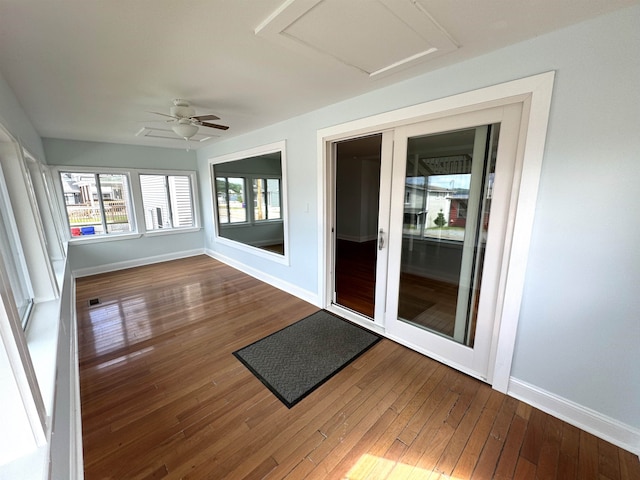 unfurnished sunroom featuring ceiling fan