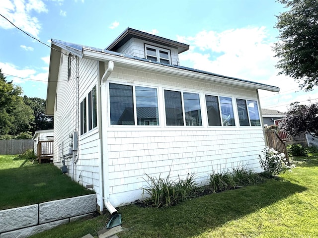 view of property exterior with a yard