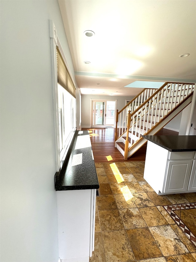 interior space featuring dark wood-type flooring and white cabinets