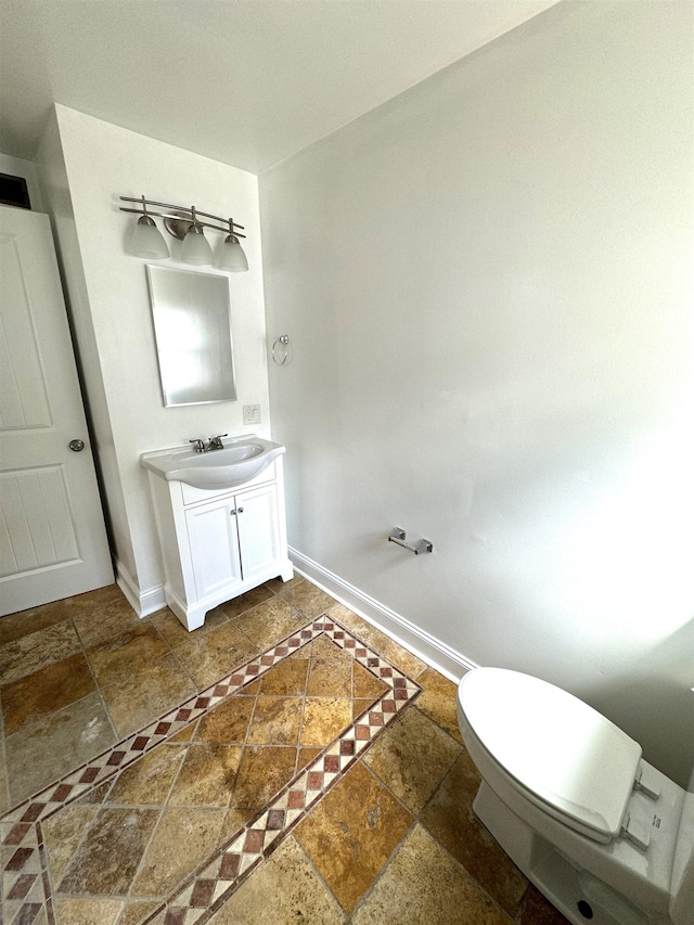 bathroom with toilet, tile patterned flooring, and vanity