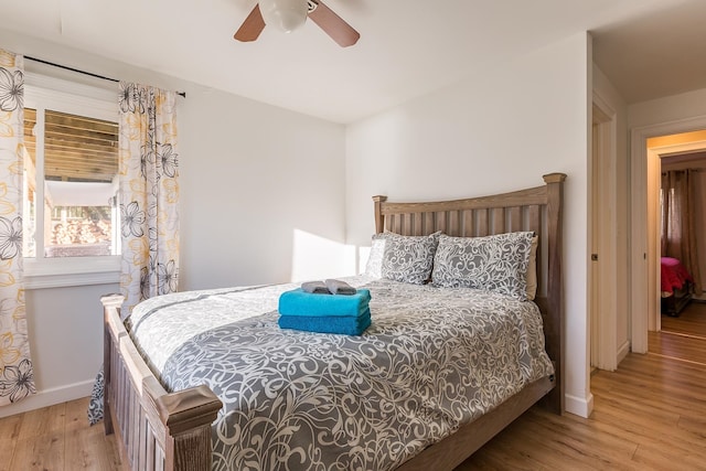 bedroom with ceiling fan and light hardwood / wood-style floors