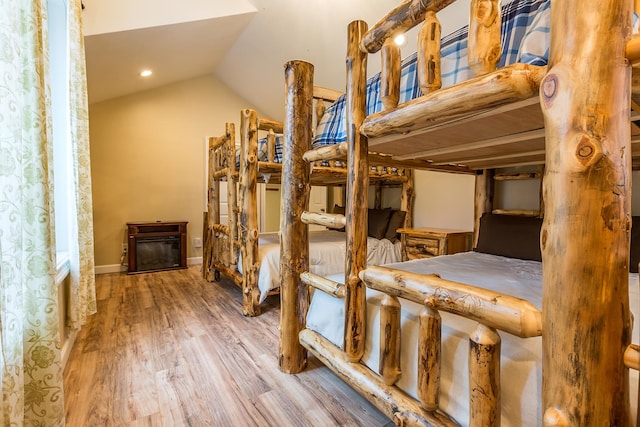 bedroom with lofted ceiling and hardwood / wood-style floors