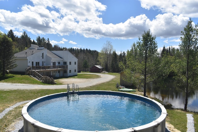 view of pool with a lawn