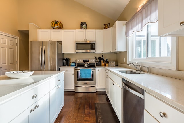 kitchen with sink, lofted ceiling, dark hardwood / wood-style floors, stainless steel appliances, and white cabinets