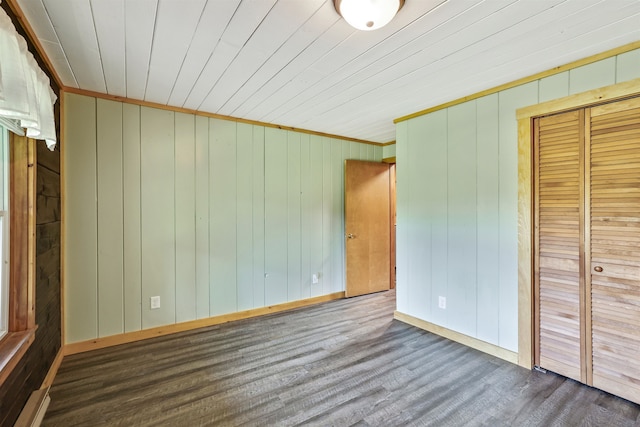 unfurnished bedroom with a closet, ornamental molding, and hardwood / wood-style flooring