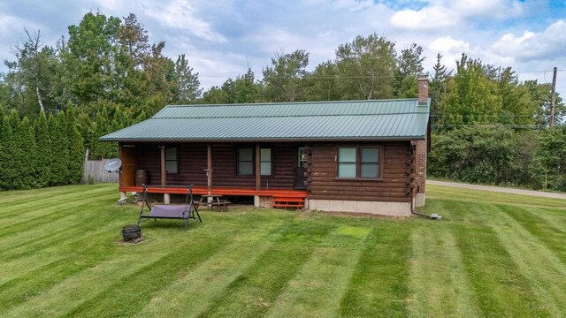 back of property featuring a lawn