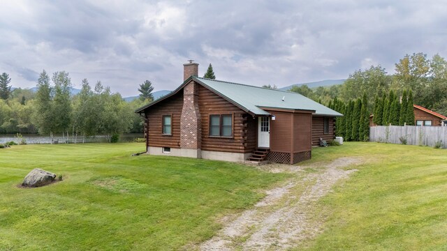 back of house featuring a yard