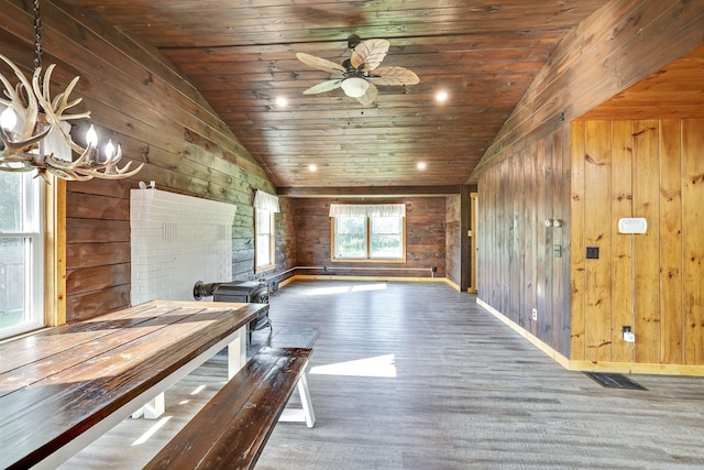 interior space featuring hardwood / wood-style flooring, wooden walls, lofted ceiling, and wooden ceiling