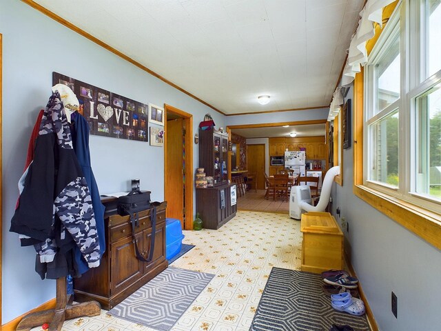 interior space featuring light tile patterned floors and ornamental molding