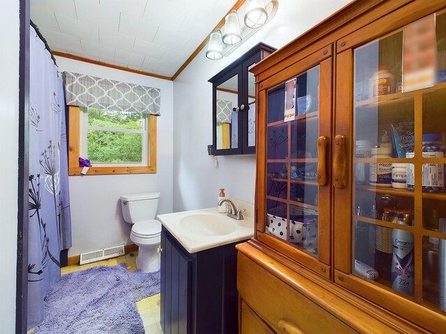 bathroom featuring ornamental molding, vanity, and toilet