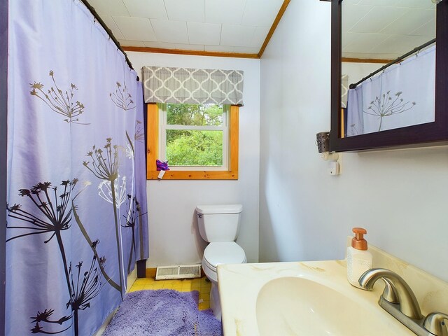 bathroom with a shower with curtain, toilet, ornamental molding, tile patterned floors, and sink