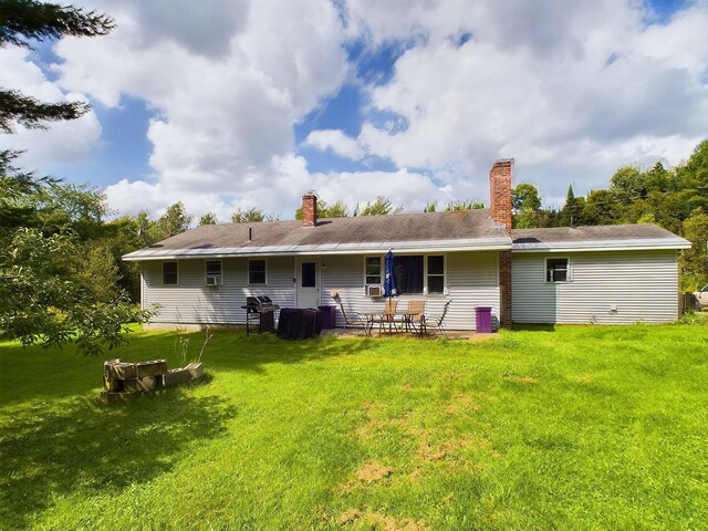 back of house with a lawn