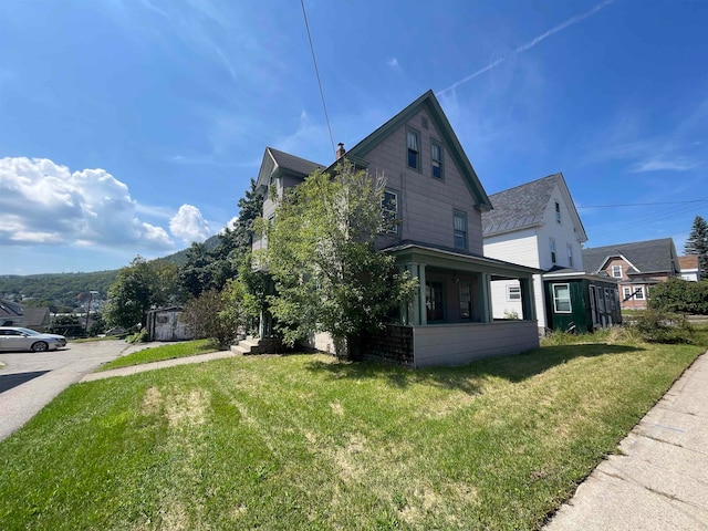 view of side of home with a lawn