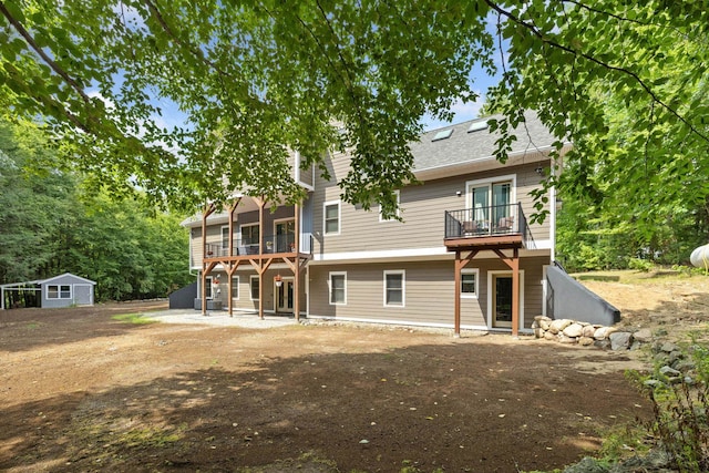 back of house featuring a balcony