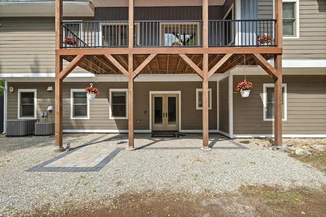 back of house featuring a balcony, french doors, and a patio area