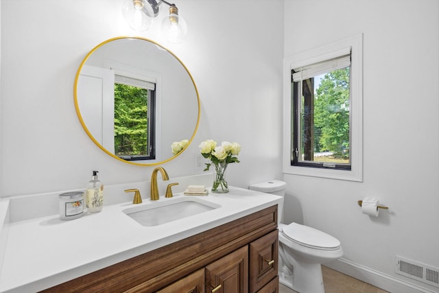 bathroom with tile patterned flooring, toilet, and vanity