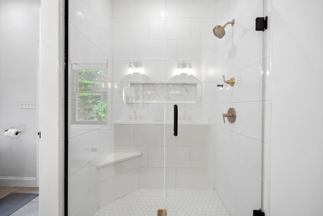 bathroom with a shower with shower door