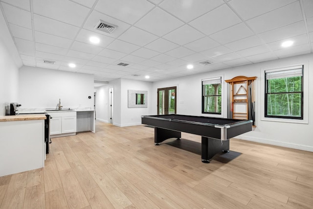 recreation room featuring pool table, sink, light wood-type flooring, and a drop ceiling