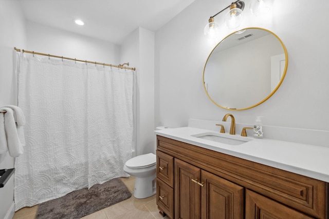 bathroom featuring vanity, toilet, and tile patterned floors