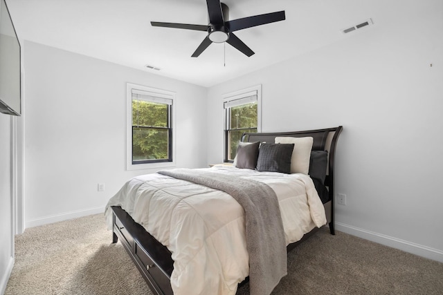 bedroom with ceiling fan and light carpet