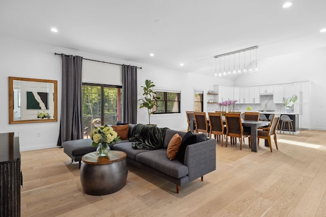 living room with light wood-type flooring and sink