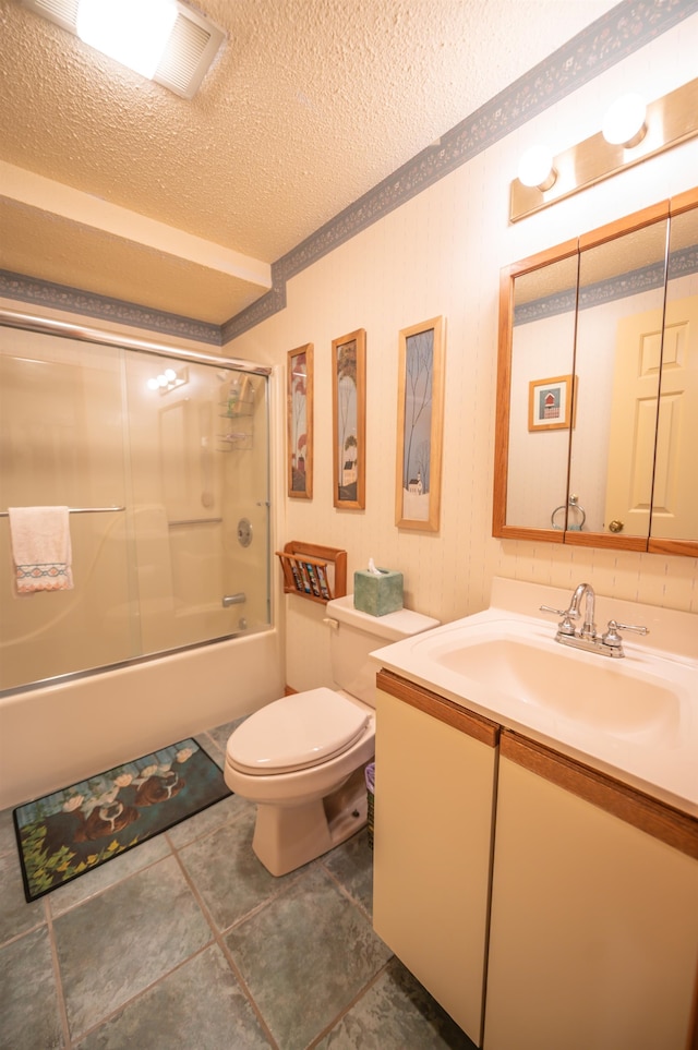 full bathroom with toilet, tile patterned floors, vanity, a textured ceiling, and enclosed tub / shower combo