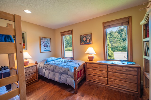 bedroom featuring dark wood-type flooring and a textured ceiling