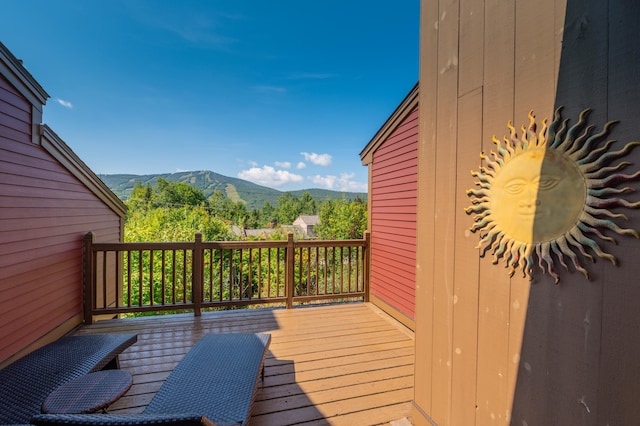 wooden deck with a mountain view