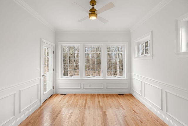 unfurnished sunroom with ceiling fan