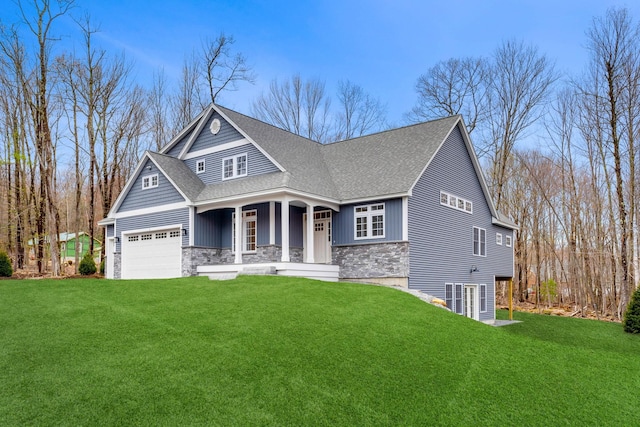 craftsman house with covered porch, a front yard, and a garage