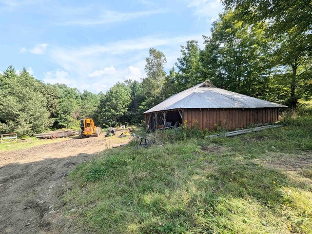 2454 W Barnet Rd, Barnet, VT 05821 - view of yard featuring an outdoor structure and a view of trees