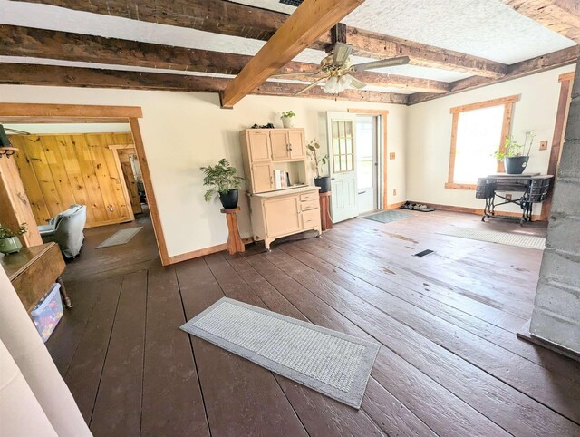 2454 W Barnet Rd, Barnet, VT 05821 - living room with dark wood finished floors, baseboards, beam ceiling, and a ceiling fan