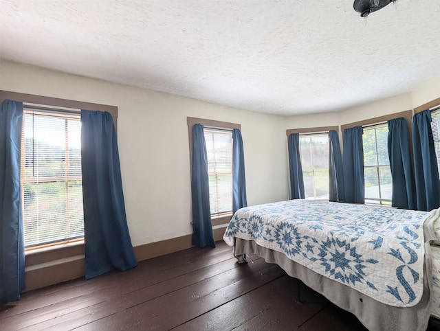 2454 W Barnet Rd, Barnet, VT 05821 - bedroom featuring wood-type flooring, multiple windows, baseboards, and a textured ceiling