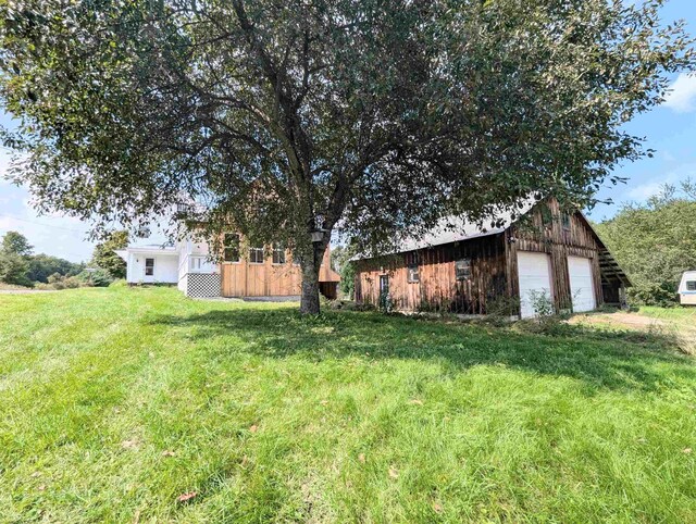 2454 W Barnet Rd, Barnet, VT 05821 - view of grassy yard with a garage and an outbuilding
