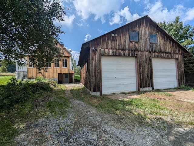 2454 W Barnet Rd, Barnet, VT 05821 - detached garage featuring central air condition unit and dirt driveway