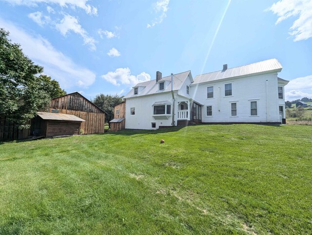 2454 W Barnet Rd, Barnet, VT 05821 - rear view of property with a chimney, a lawn, and metal roof